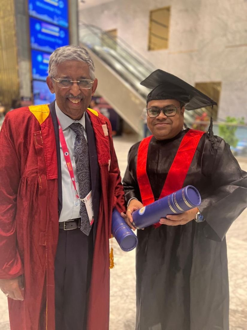 Dr. Vishal Gupta in convocation gown with a senior faculty member